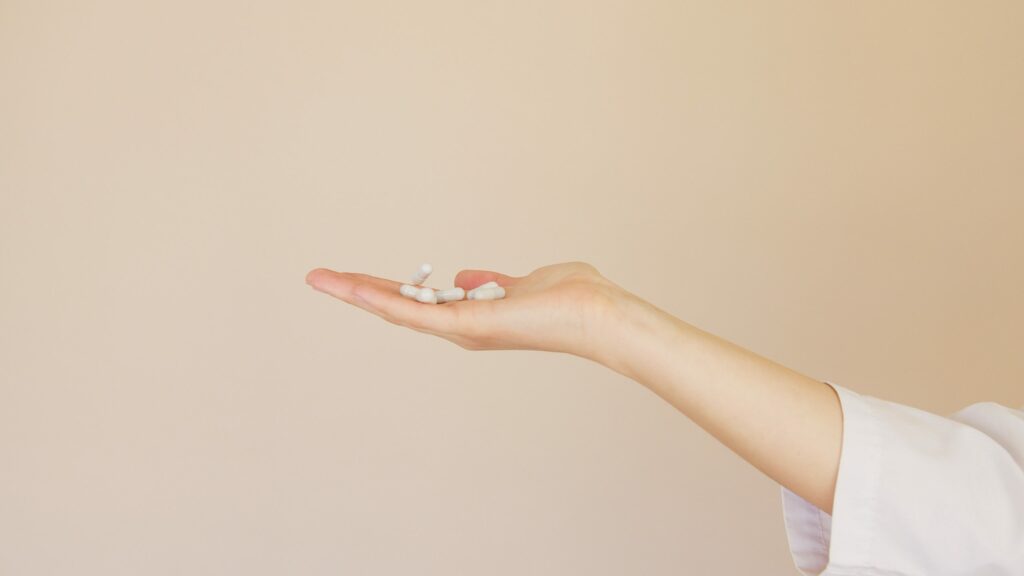 Woman holding supplements.