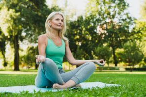 Smiling woman on a yoga mat.